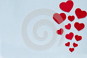 Horizontal card Valentine`s Day. Red hearts on a gray-blue background