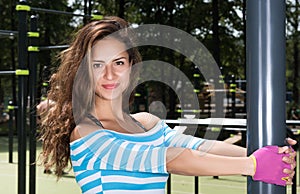 Horizontal closeup portrait of a beautiful young woman on the Playground. The woman grabs your hands post