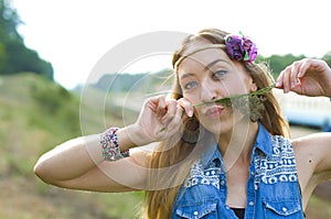 Horizontal closeup portrait of a charming hippie on nature background