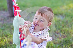 Horizontal closeup portrait of a funny little girl playing outdoors