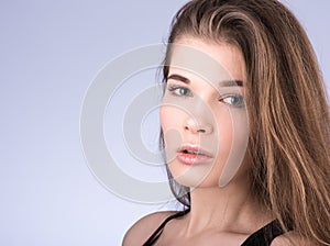 Horizontal closeup portrait of a young beautiful woman with long flowing hair