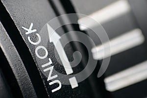 Horizontal closeup shot of a black and white camera lens lock