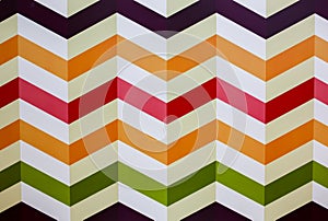 Horizontal colorful zigzag lines on the white background. Real strips painted on wall. Bright zig zags for wall paper. Children