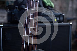 horizontal detail of the fret board of a bass guitar on amp background