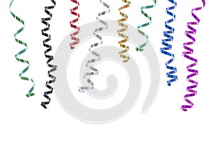 Horizontal festive image with close-up multi coloured rolls curly ribons hanging from the top on black backgroung photo