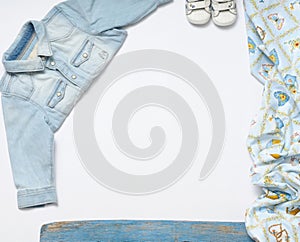 horizontal frame of jeans stuff and sneakers for baby boy on white background