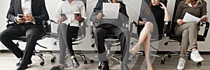 Horizontal image diverse applicants sitting in queue waiting job interview