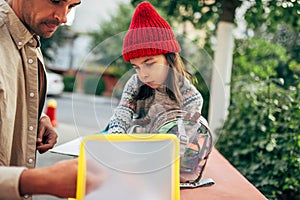 Horizontal image of a father meeting his little girl after school. Father enjoying the time together with his child outside. Daddy