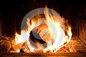 Horizontal Image of Fire Log Burning Intensively in Firepit photo