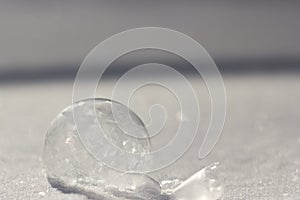 Horizontal image of frozen bubble in sparkly snow