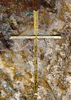 Horizontal image of a golden cross on luxerios brown marble background.