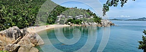 Horizontal image picturesque landscape with turquoise blue bay of Siam gulf, exotic stones hillside hotel houses for vacationers photo