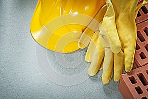 Horizontal image of red bricks hard hat safety gloves on concret