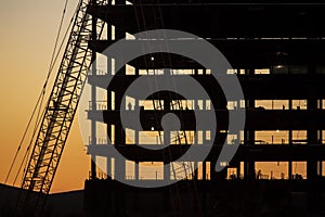 Horizontal image of silhouette of construction project involving large building photo