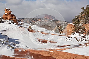 A horizontal image of windblown snow on and around the hoodoos in a little place in Southern Utah called Hoodoo city