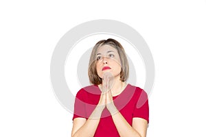 Horizontal image of a young Caucasian woman praying, looking up with open eyes, hoping for the betterment of the world around us, photo