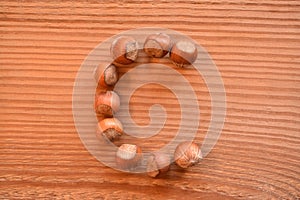 The letter C made with hazelnuts