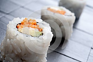 Horizontal macro of 3 rolls of sushi