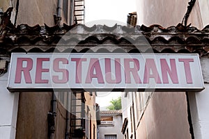 Horizontal old white ancient signage on shop restaurant front