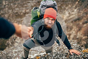 Horizontal outdoors image of traveler bearded man trekking and mountaineering during his journey.