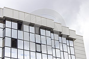 Horizontal perspective shot of multiple floor of a glazing facade building with overcast sky in Ankara at Turkey