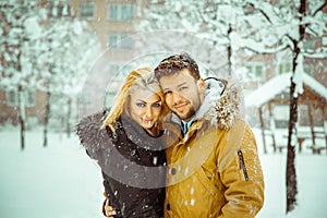 Horizontal photo of betrothed couple in love looking at camera a