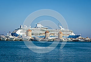 Big cruiser behind ancient mills in capital town of Rhodes island