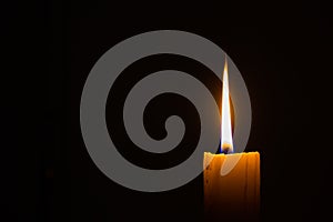 Horizontal photo of candle on black background with copyspace