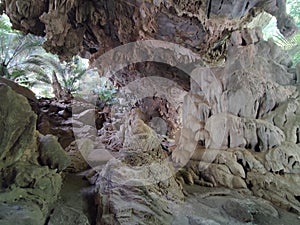 Horizontal photo of cave with stalactites and stalagmites in Thailand