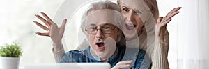 Horizontal photo mature couple looking at laptop screen feels excited