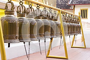 Row of Buddhist Prayer Bells outside Wat Phra Singh temple. Chiang Mai, Thailand.