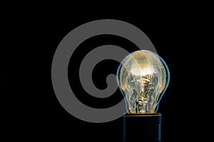 Single glass bulb mounted in socket with flame inside