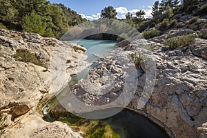 Horizontal photo of the source of Fuente Caputa, between rocks, in the town of Mula