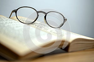 Horizontal photo in vintage style glasses and an old book