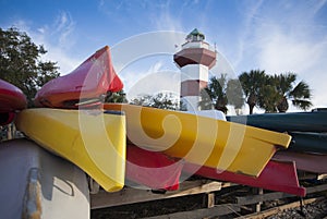 Colorful Kayaks in front of a Red and White Lighthouse