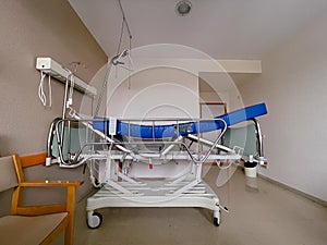 Horizontal photograph of a hospital bed empty
