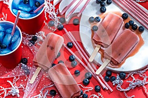 Horizontal Photograph of Red White and Blue Picnic Scene with Popsicles and Iced Drinks