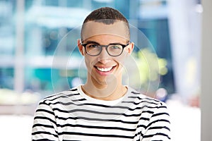 Horizontal portrait of handsome young man smiling with glasses