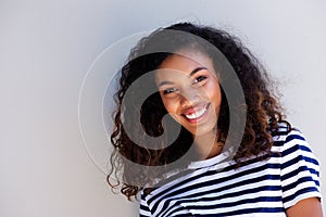 Horizontal portrait of happy young african woman smiling against white background