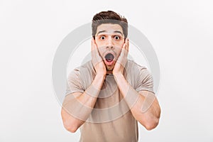Horizontal portrait of scared man grabbing his face and screaming in stress, isolated over white background