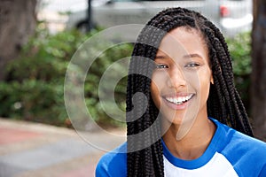 Horizontal portrait of smiling young african american woman outside