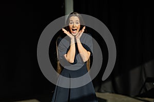 Horizontal portrait of surprised beautiful girl in black dress