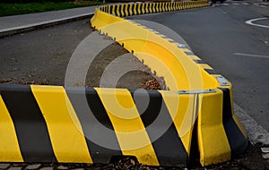 Horizontal road marking lanes. highway concrete barriers on the road. vehicle collision lane separator. yellow color with black st