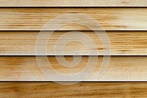 Horizontal rows of cedar wood siding as an exterior wall close view