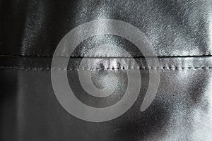 Horizontal seam on black artificial leather