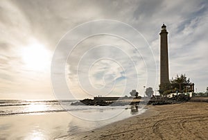 Horizontal shot of the beautiful beach in Maspalomas, with Faro de Maspalomas or Maspalomas lighthouse, in the