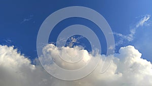 A horizontal shot of bright blue sky with puffy white clouds.sky view