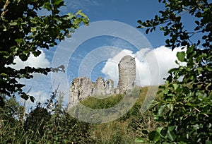 Horizontal shot of the Clun Castle Shropshire, UK in summer through the trees