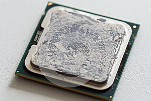 Horizontal shot of a dirty  and old computer processor chip on a white surface