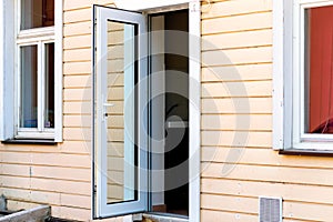 Horizontal shot of glass front door of an upscale home with windows/Exterior shot of an open old glass Door
